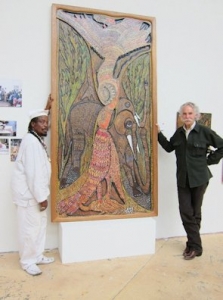 Prince and Henry Glassie with the painting "Kissing Birds" at an exhibition.