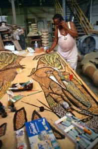 Prince working on the sculpture's painting "Kissing Birds" at Material Culture.
