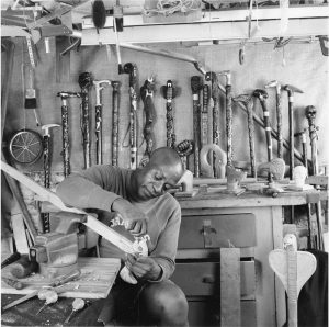 1. Master carver Milton O. Jews in his basement workshop; this 1989 image by Roland Freeman is the one he came to call his “family portrait.” Roland L. Freeman, © 2001. Reprinted with permission of the artist.